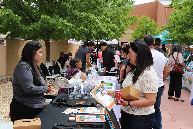 Attendees visit vendor booths and browse health resources at an outdoor community health fair