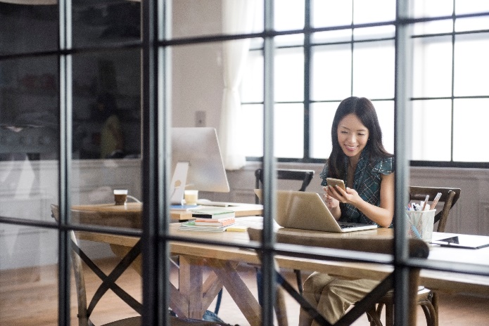 A person sitting in front of a window Description automatically generated