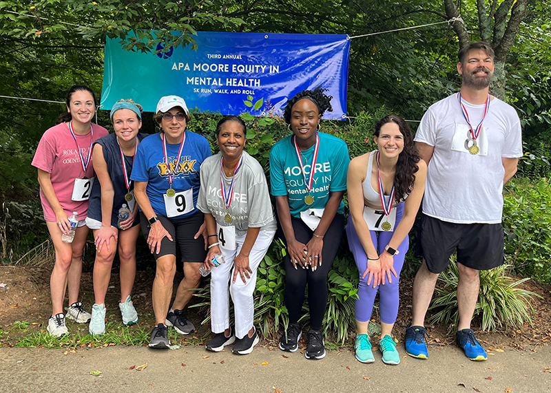 participants pose with the finishing medals at the 2023 Moore Equity in Mental Health 5K