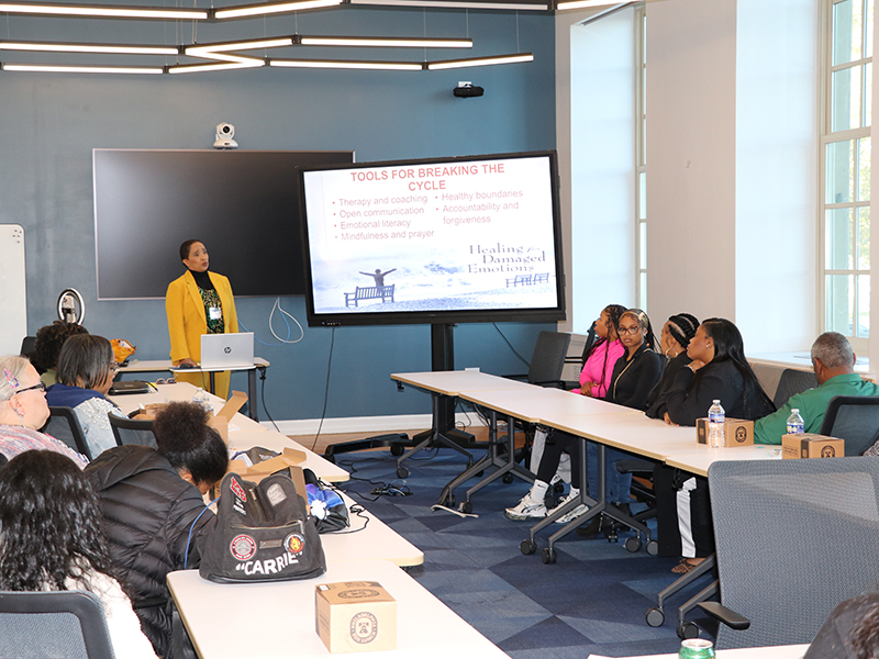 Facilitator giving presentation while attendees listen