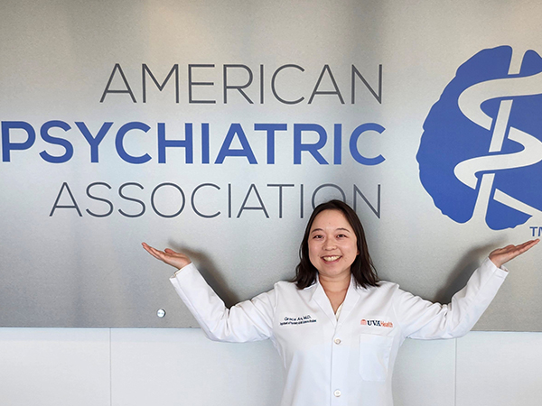 Grace An in front of APA banner at 2025 Spring Leadership Summit
