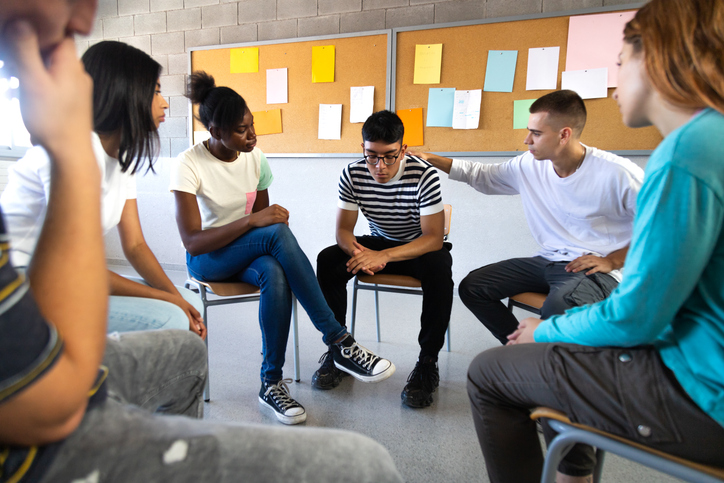 group of youth sitting and talking