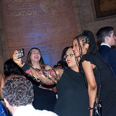 Two people taking a selfie at the 2024 APAF Benefit