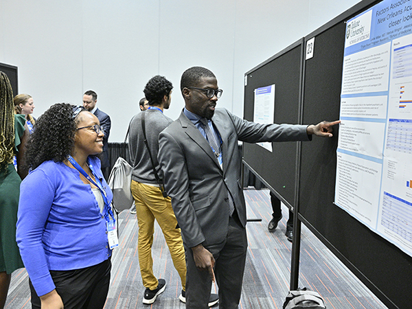 poster presenter discusses their research with an attendee