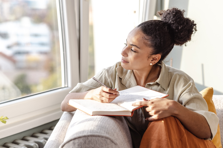 Woman writing in a journal