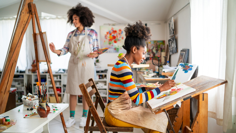 women working on paintings