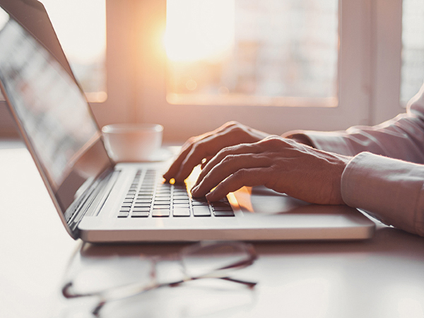 person typing on laptop