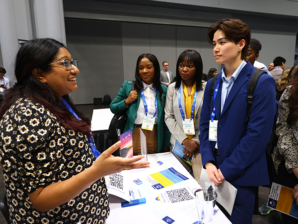Attendees talking to booths at the Residency Fair at the 2024 APA Annual Meeting