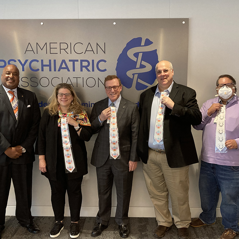 APA Board of Trustee members showing off the Rorschach ties they received for donating more than $1,000 to the endowment campaign