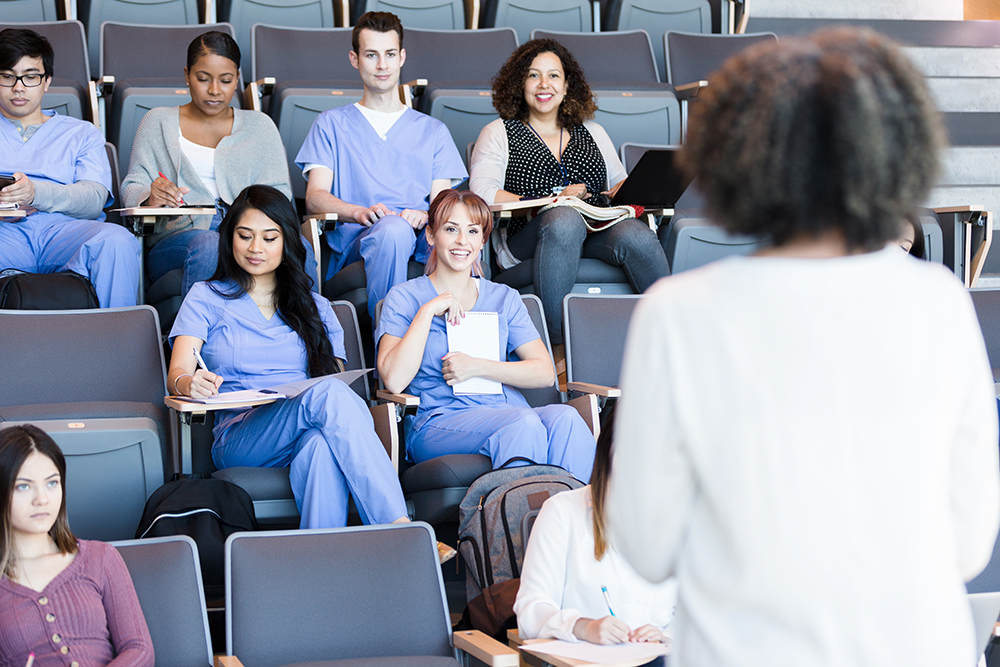 a group of medical students seated in an auditorium classroom