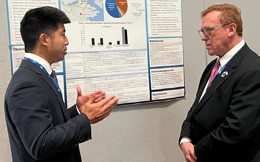 Dr. Saul Levin talking to Dr. Michael Hsu at his poster presentation at the 2023 Annual Meeting
