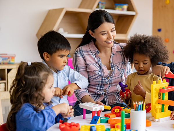 Kids playing with toys under supervision at daycare