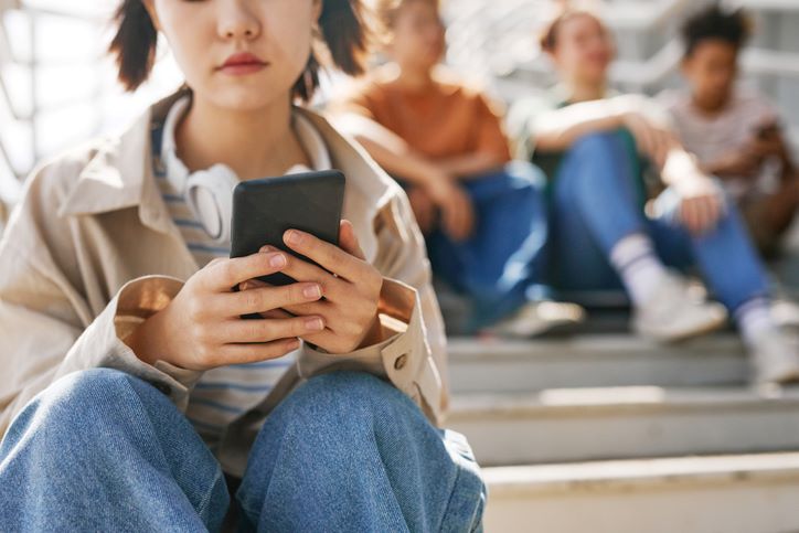 teen girl looking at her phone