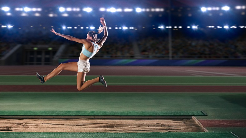 woman in mid-air long jump
