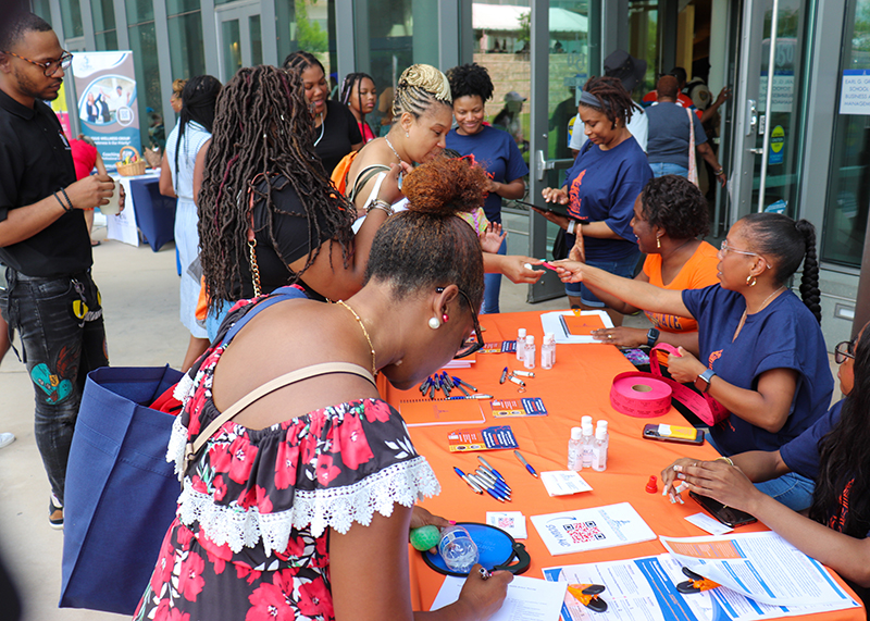 participants at the Mental Health Community Fair visit with a booth