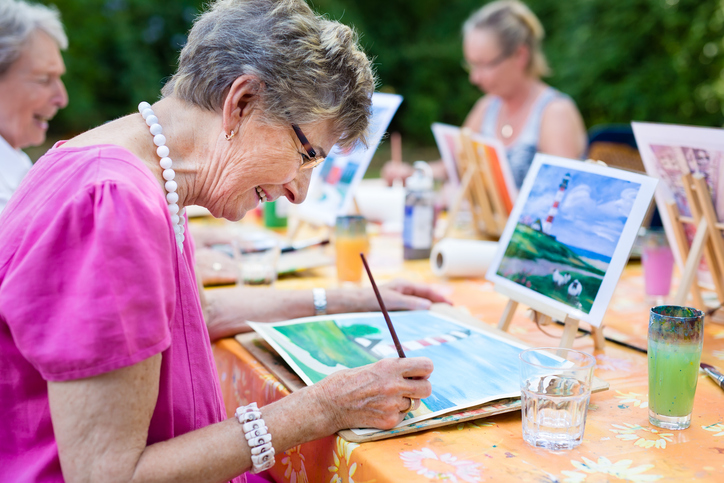 group of older women working on artwork together