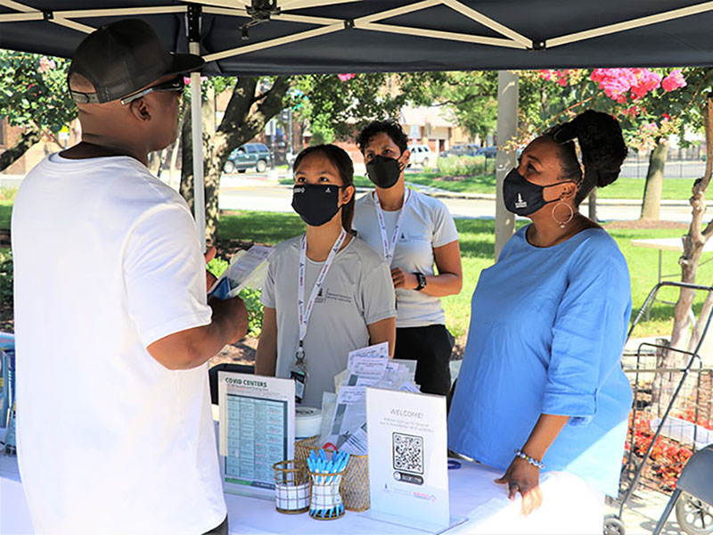 participants interacting with a booth at the 2022 Moore Equity in Mental Health Community Fair