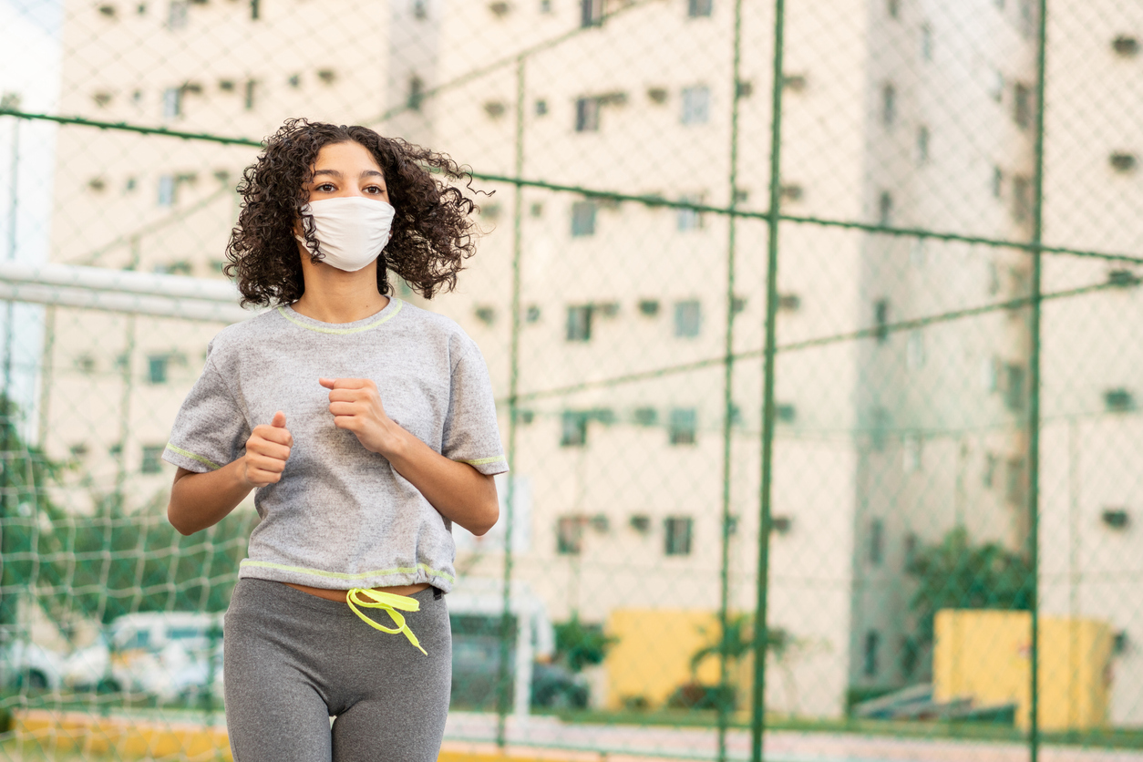 Girl running with a mask on