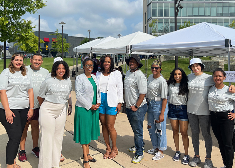 participants pose for a photo outside at the community fair