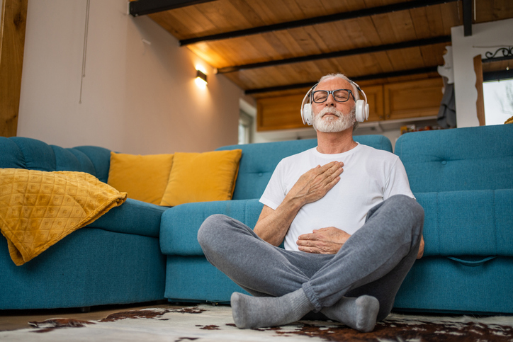 man with headphones practicing deep breathing