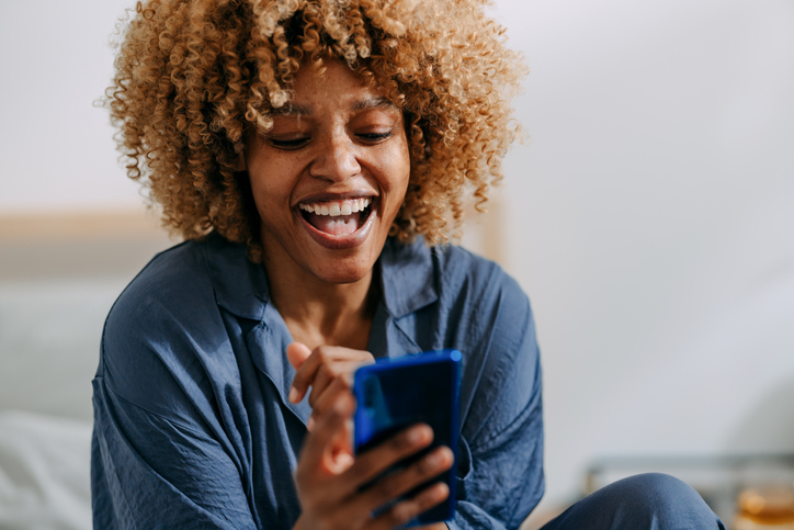 woman smiling at phone