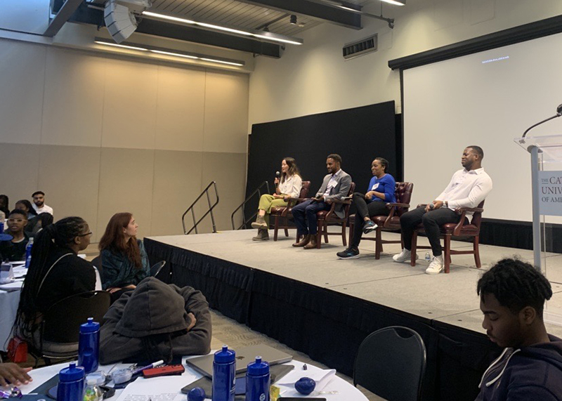 2023 youth summit participants listen to the panel on stage